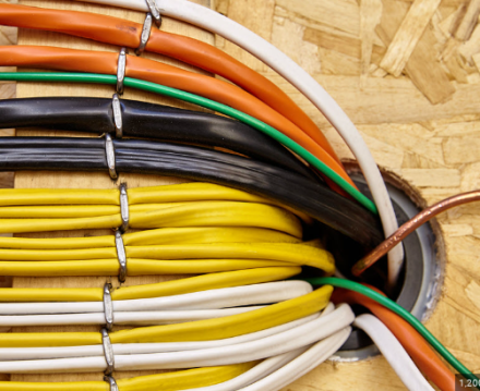 Detailed view of blue ethernet cables connected to a network switch in a data center.